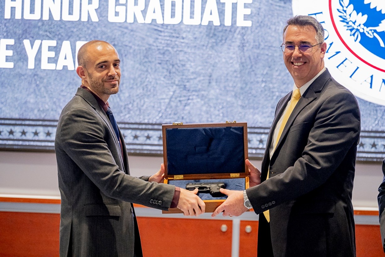 Acting FLETC Director Paul E. Baker and Special Agent Christopher Whitehurst during the Honor Graduate of the Year Ceremony, in Glynco, Ga., May 29, 2025. (FLETC OPA/David Tucker)