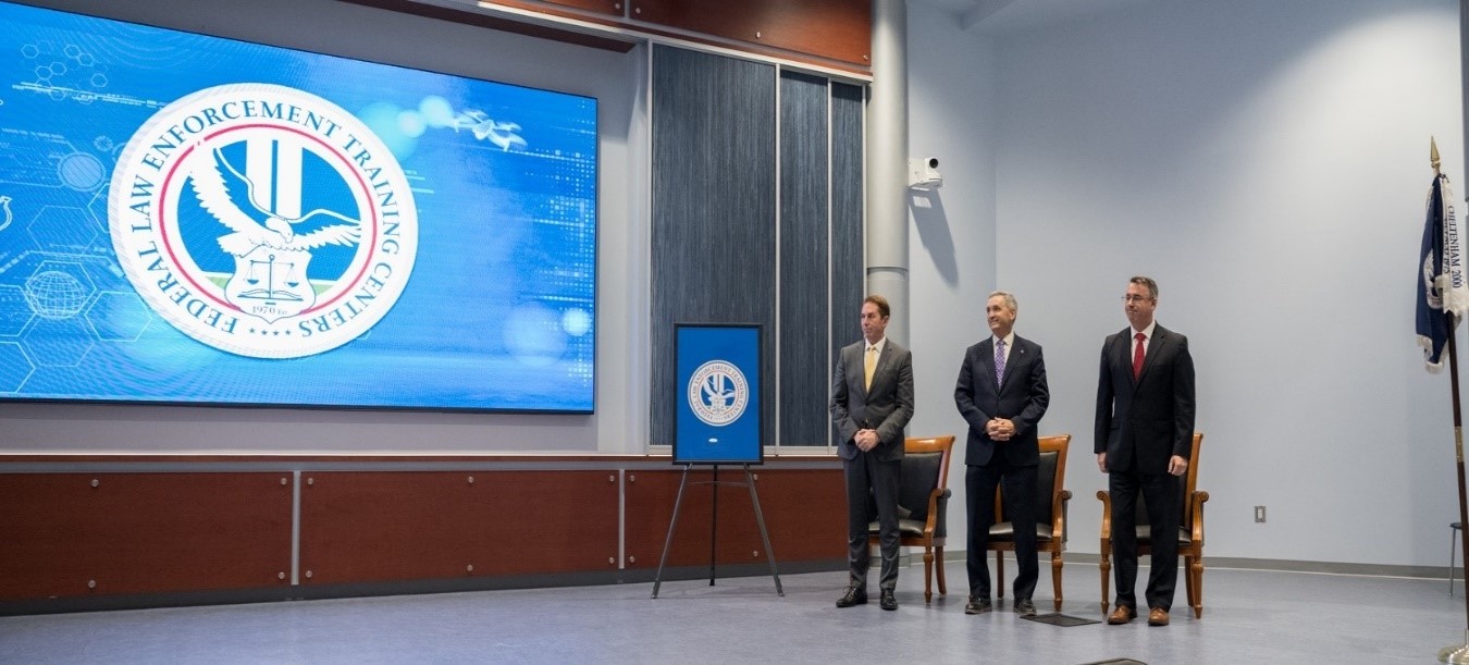 The new FLETC Seal was revealed during the FLETC 55th Anniversary Celebration.  Pictured (left to right) DHS Deputy Secretary Troy Edgar, DHS Senior Official Performing the Duties of the Undersecretary for Management, Mr. Benjamin C. Huffman, and Acting FLETC Director Paul E. Baker, July 1, 2025, Glynco,GA. (photo by Mindy Vu, OPA)