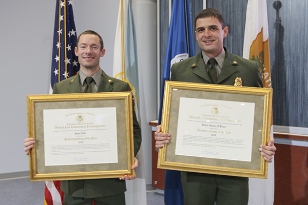 Ranger Sean Nelb, 2019 FLETC Honor Graduate (LEFT) and Ranger Dillon O’Brien, 2020 FLETC Honor Graduate (RIGHT) display their honor graduate award certificates after receiving during the ceremony held November 30, 2021, at FLETC. (Photo by Brandon Spragins, FLETC/OPA)