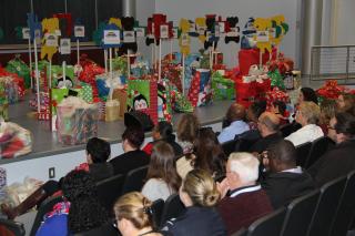 Gifts for CASA children on the stage at FLETC Auditorium, Bldg 912 Gifts for CASA children on the stage at FLETC Auditorium, Bldg 912